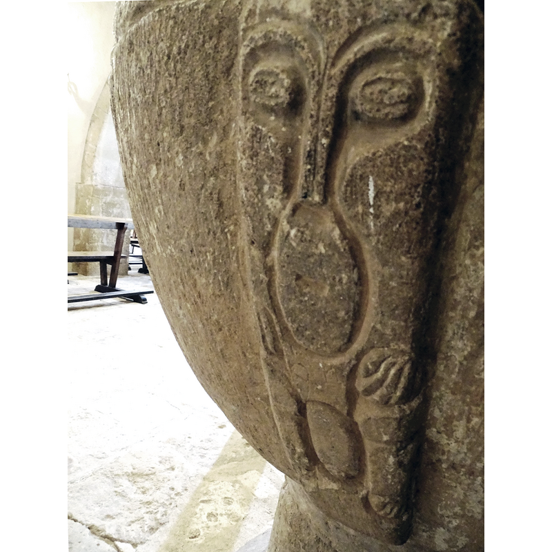 a humanoid shape carved on  one of the squarish ribs; could be a full figure