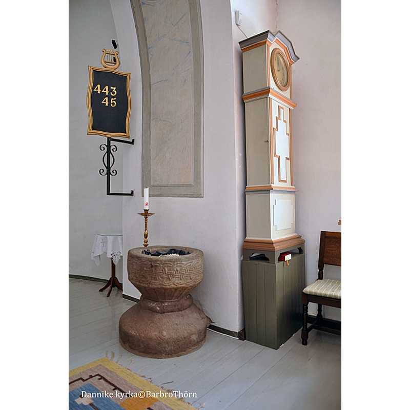 the medieval font seen here against the south pillar of the chancel arch