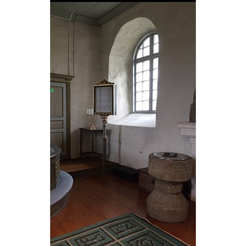 the font at the east end of the nave, south side