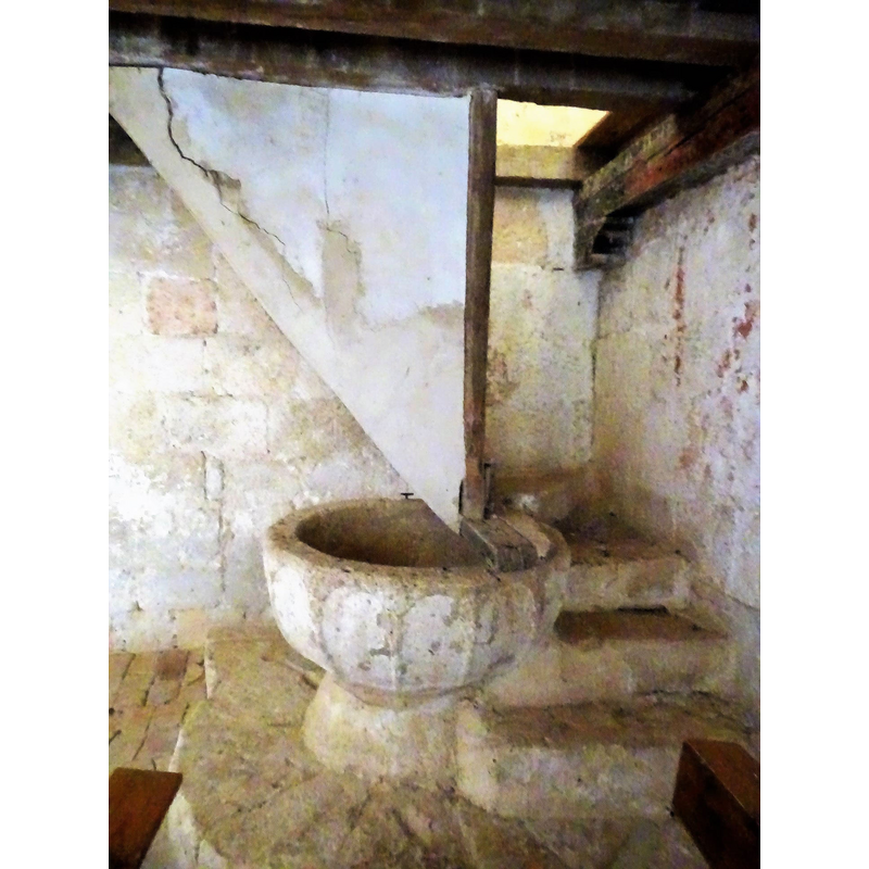 it looks like the casing for the gallery stairs was built without moving the font, and the upper stairs lean on a beam across the top of the font