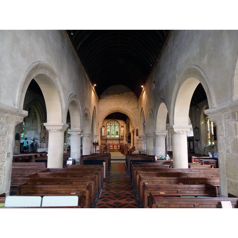 Source caption: "Corsham Church (St. Bartholomew), 5 May 2018. Remains of early 11th Century Saxon Church in south wall of chancel and part of west wall of nave now incorporated in the arcade. Rest of church mostly 12th Century Norman and 14th Century Decorated with 15th Century nave roof but heavily restored (i.e. virtually rebuilt) in 1875-78 by G E Street who demolished old central tower and built a new south tower with spire whilst C F Hansom remodelled the chancel in 1880 and added the Methuen Chapel. Pictured is the 12th Century Norman nave (looking towards the chancel) although the south arcade incorporates the original Saxon wall."