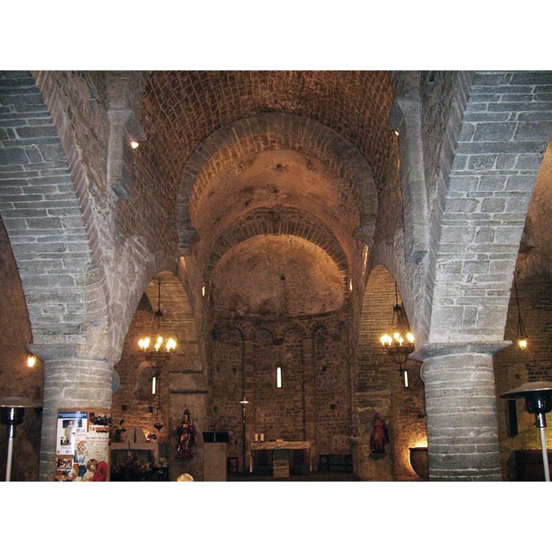 the medieval cauldron-shaped font is partially visible semi-hidden by the right pillar
