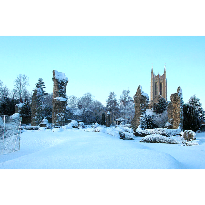 Source caption: "Part of abbey ruins in Abbey Gardens, Bury St Edmund's, Suffolk, in snow, with the tower of St James' Cathedral in the background"