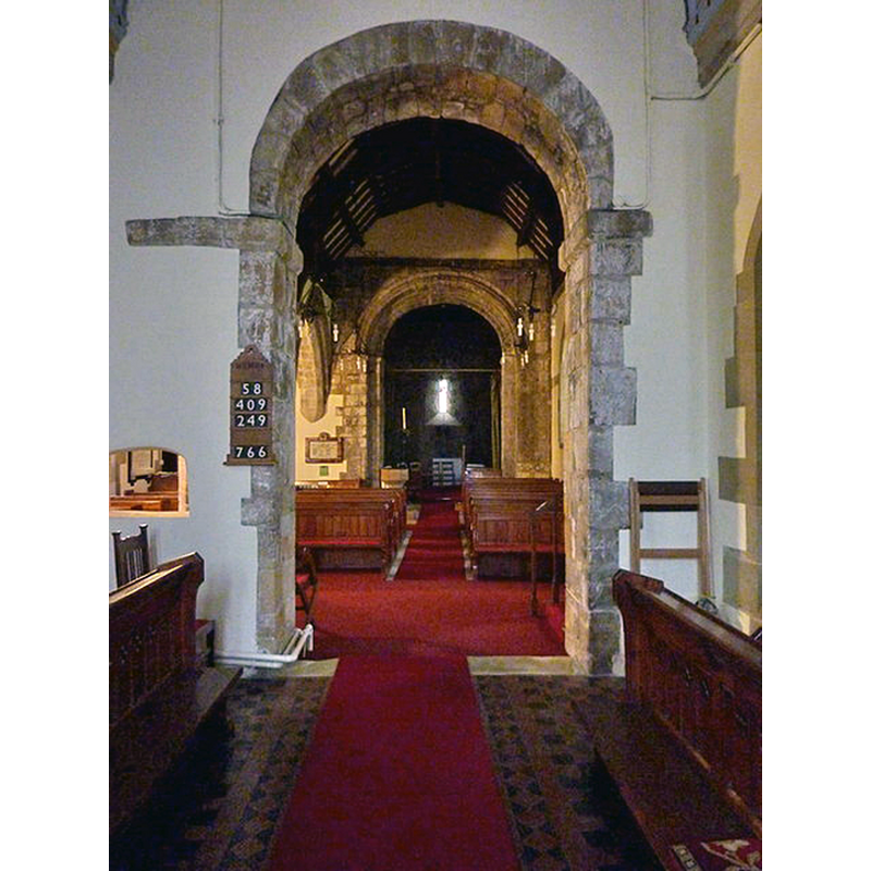the font is visible at the back, by the left [south] pillar of the tower arch