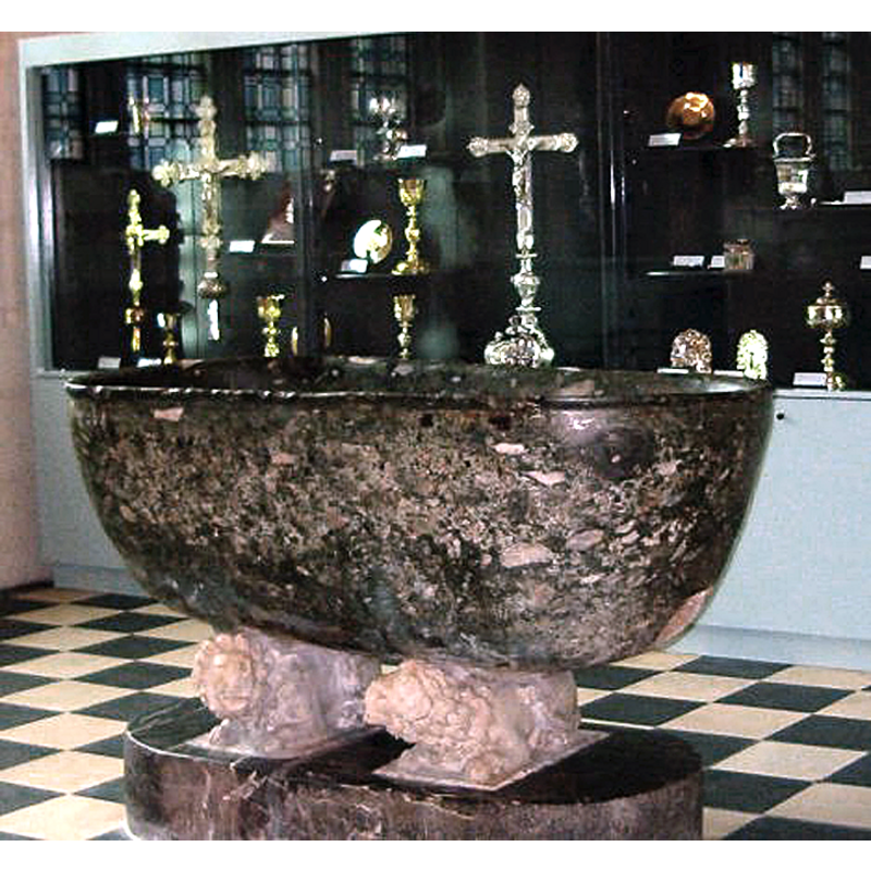 a Roman bath tub originally, later used as baptismal font until 1699; later still as holy-water stoup -- it now appears to stand in the treasury room
