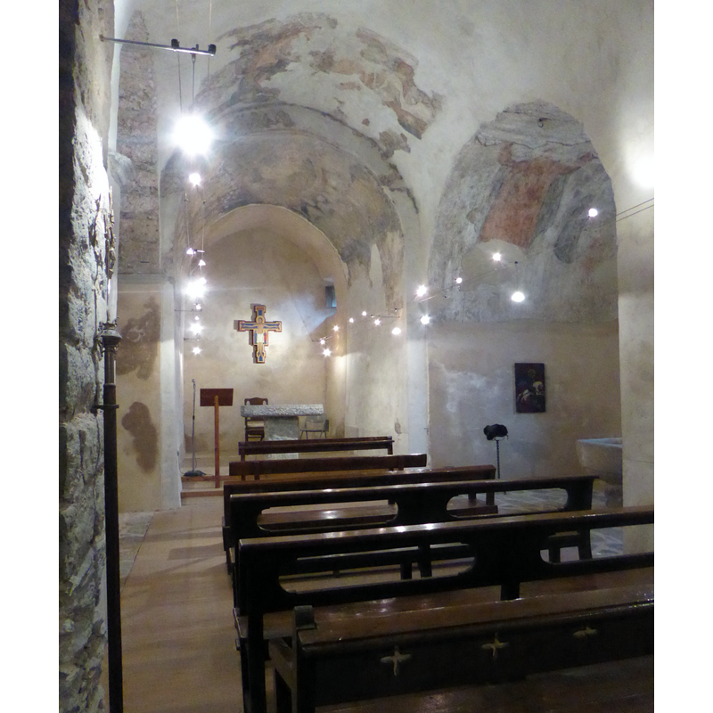 the mural paintings were uncovered in the 1990s restoration; the baptismal chapel is visible on the right [south] side