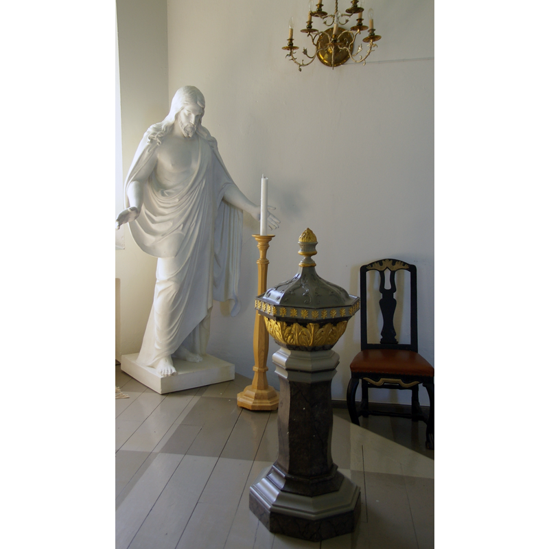 located in the southeast corner -- the new font, like the chair next to it, is probably from the time of the consecration of the new church in the 1770s