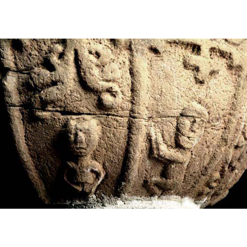 the figure stands beneath a large motif
