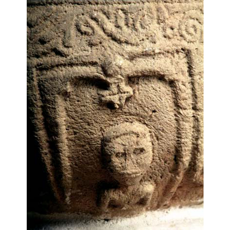 the demi-figure looks out; the cross in crossed inside