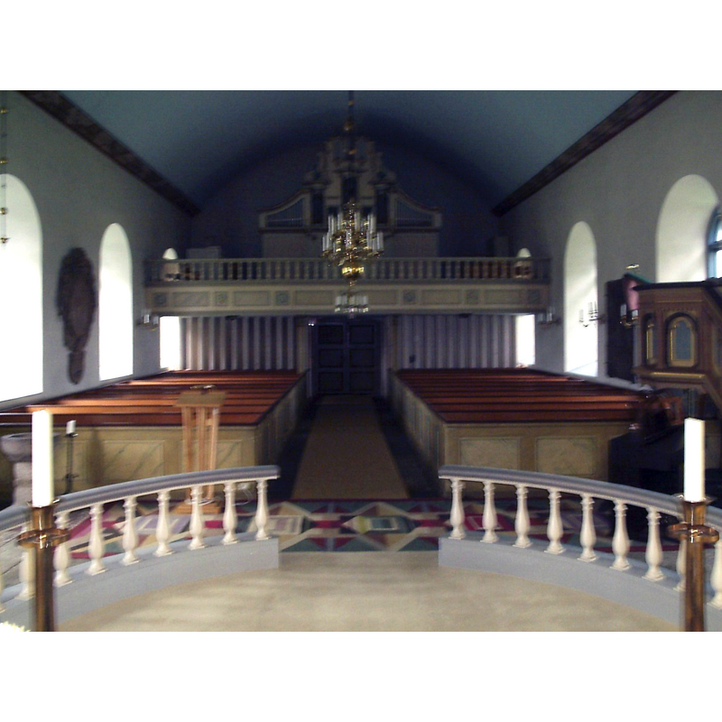 the baptismal font is partially visible in the bottom-left corner of the image