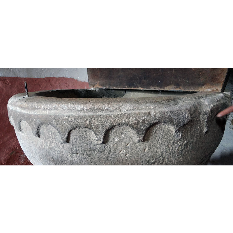all around below the upper rim; damaged in a couple of spots -- notice the metal staple on the left