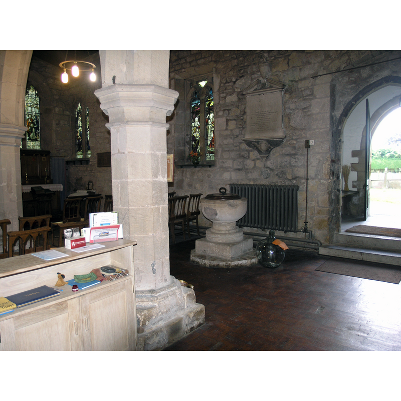 the medieval font seen in the nave, by the south entranceway