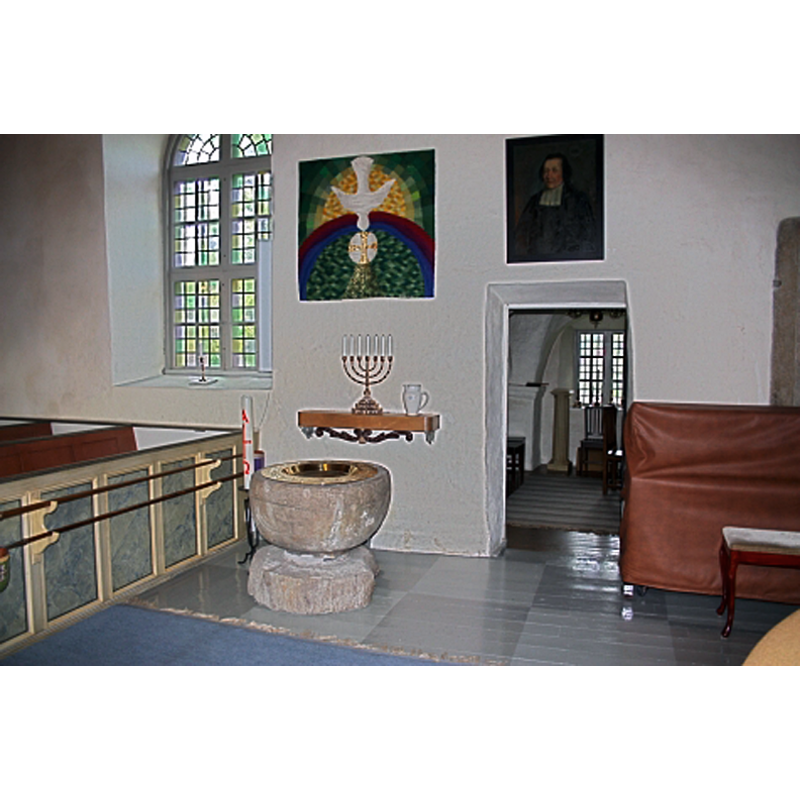 at the east end of the church, north side, by the sacristy doorway