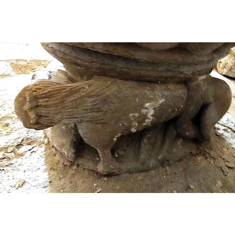 full view of the lion, head to butt; the snake coils around the lion's hind quarters