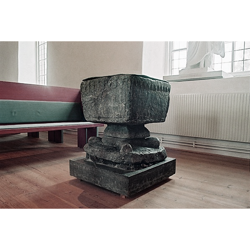 the medieval font seen at the east end of the nave, in the mid-19thC church