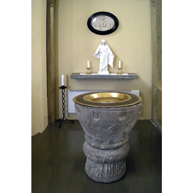 the medieval font in the new church, seen here at the east end, south side