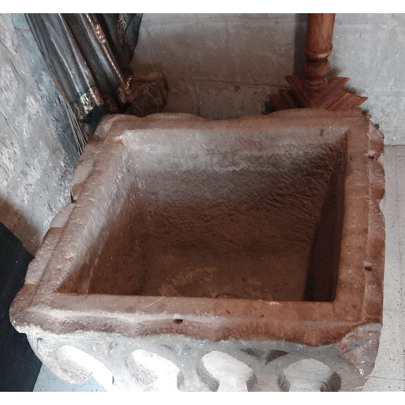 drilled holes in the upper rim are visible here; they must have housed the hardware of the font cover