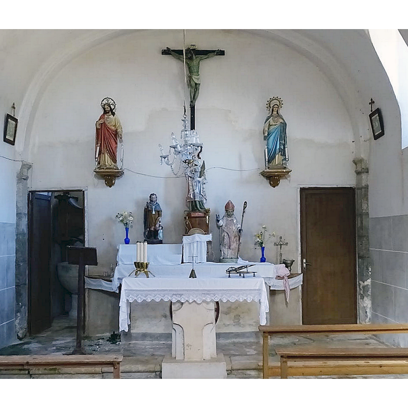 the medieval font is partially visible behind the open door to the left [north] side of the altar