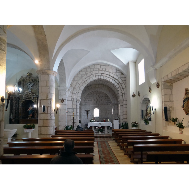 a baptismal font is partially visible on the left [north] aisle