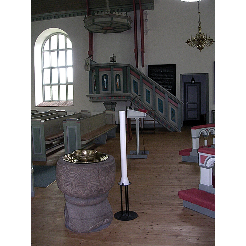 the medieval font in the southeast corner of the 1898-1899 church