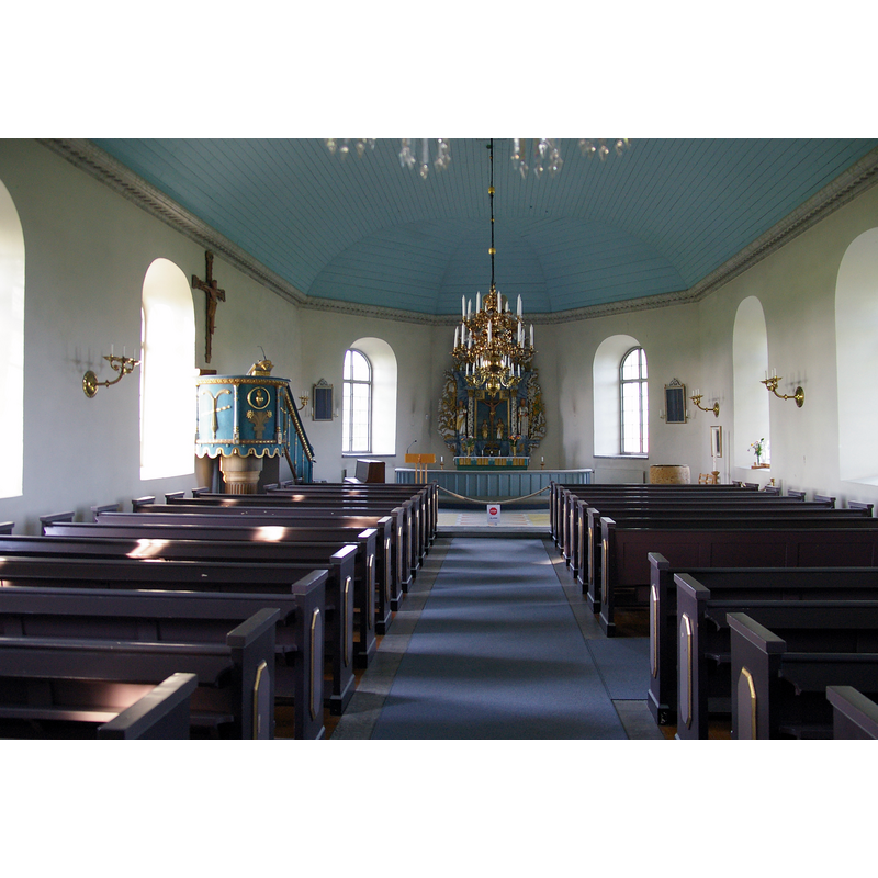 Source caption: " Karleby kyrka är en kyrka belägen i Karleby i Falköpings kommun." -- the medieval baptismal font is partially visible at the far [east] end, right [south] side
