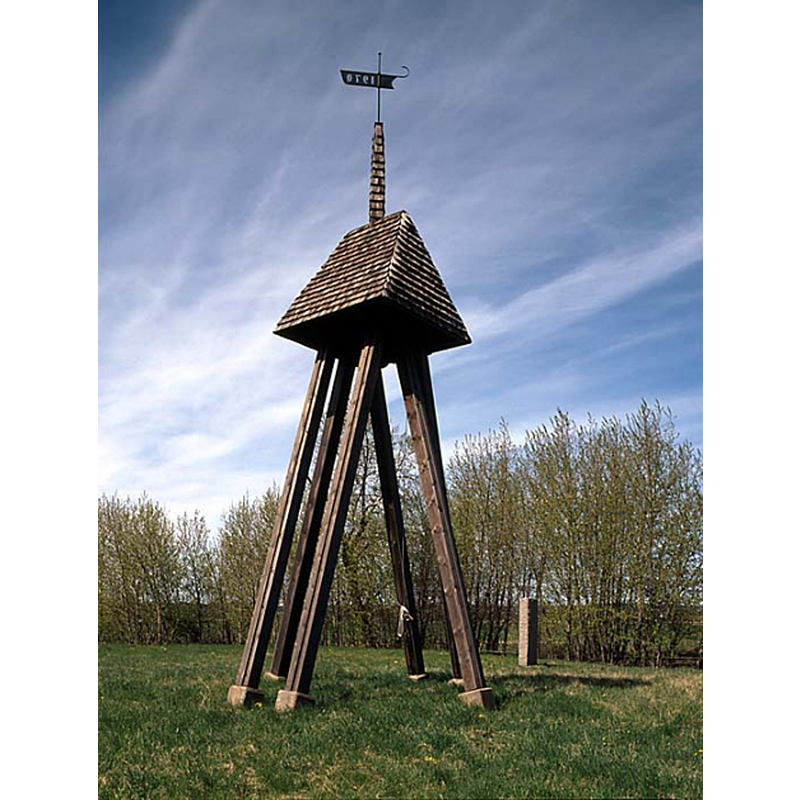 Source caption: "Klockstapelnn på Sils ödekyrkogård, maj 1996. Foto: Åke Johansson." -- a modern belfry marks the location of the site of Sil's old church; it was demolished in 1872 and most of the stone was re-used in a nearby farm