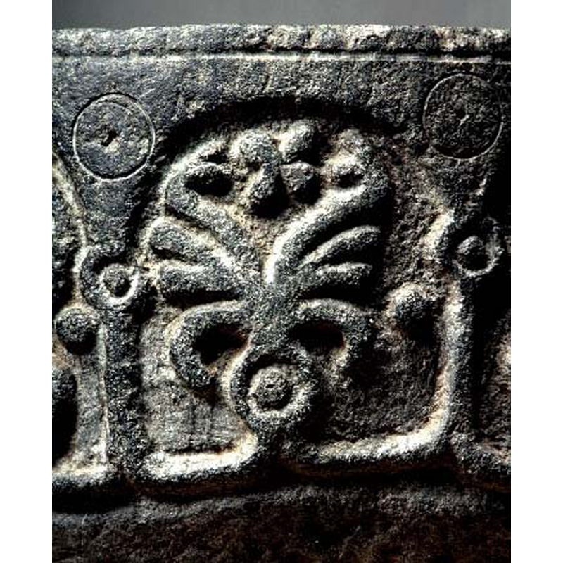 each spandrel has one of these, an incised circle with a whole in its centre; they appear to be unfinished, as if the carver intended to match the motifs that make up the 'capitals' below