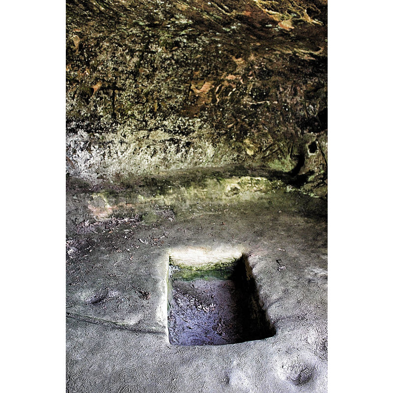 one of two quadrangular depressions in the ground of the Cueva de la Vieja; they have been described as possible baptismal fonts in some sources