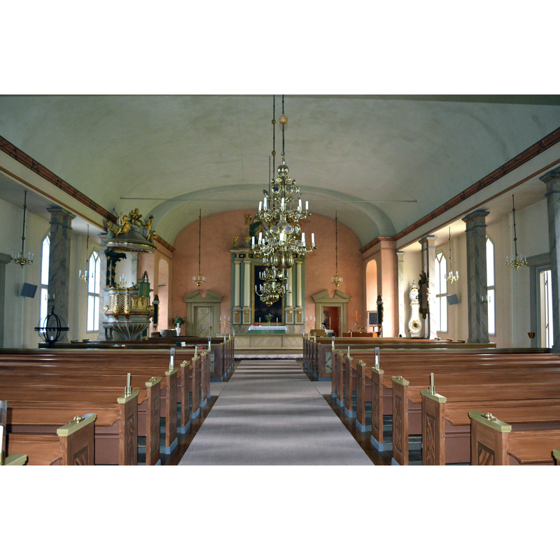the medieval baptismal font is partially visible in the northeast corner, by the pulpit
