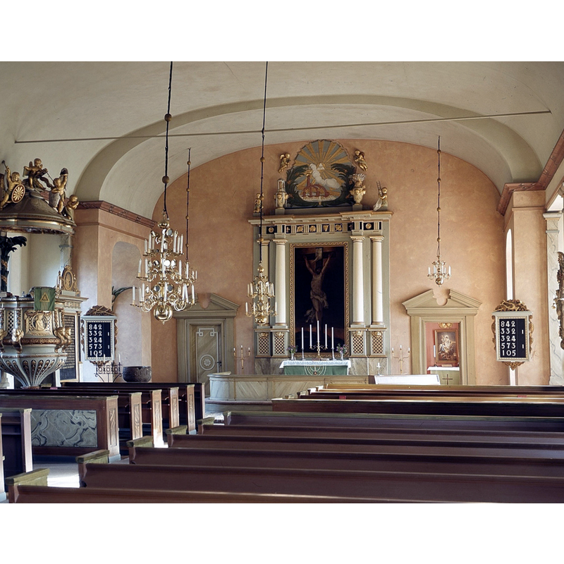 the medieval baptismal font is partially visible in the northeast corner, by the left psalm board