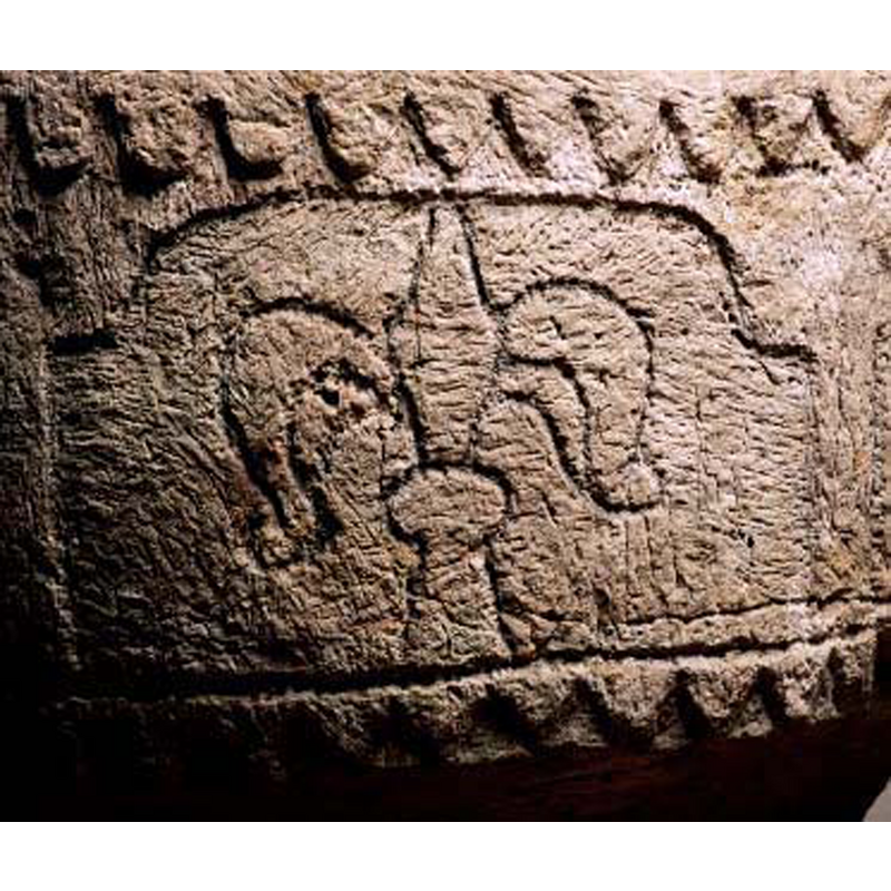 very irregularly carved; the left side here is clearly scalloped, but the centre and left the scallops become pointed into a saw-tooth pattern