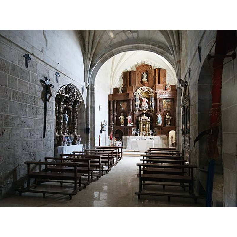 the baptismal font is partially visible in an alcove, bottom-right corner of the image