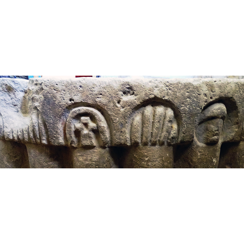 inscribed in one of the arch-heads with an added arch-head as well