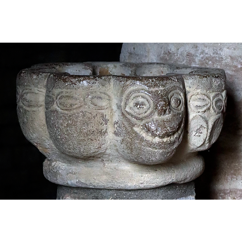 four grotesque faces on every other bulge of the basin