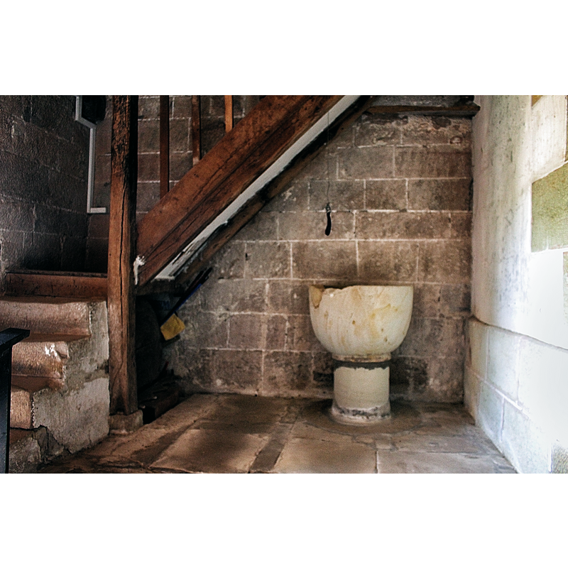 at the west end, beneath the stairs to gallery