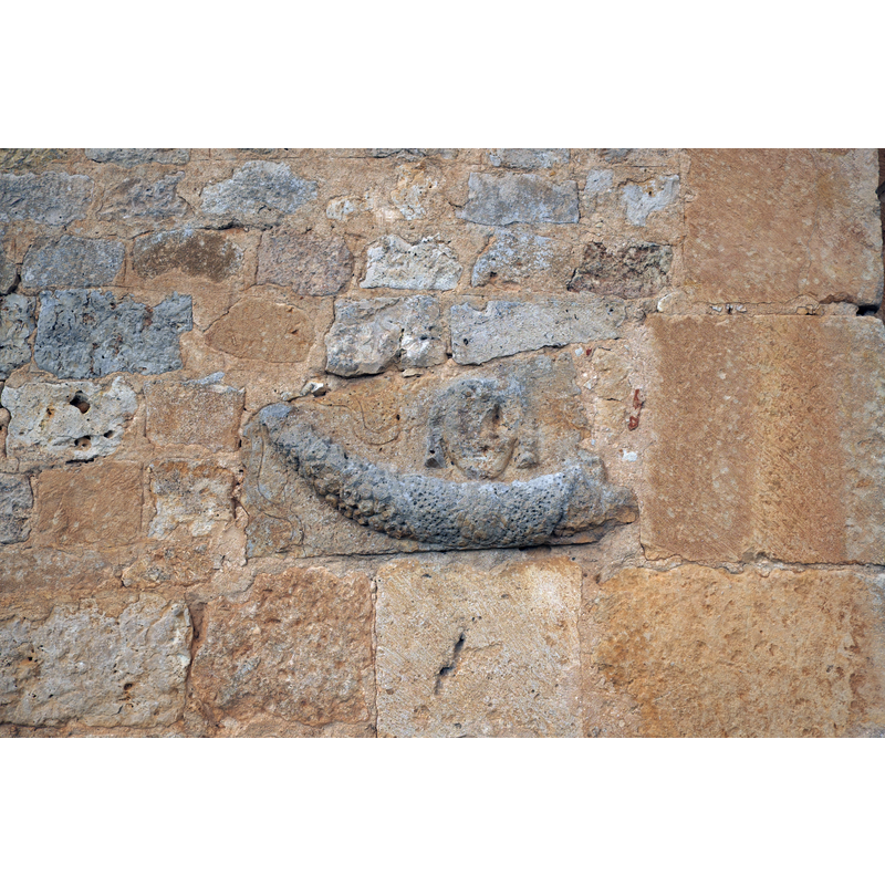 Source caption: "Ermita del Santo Cristo de San Sebastián in Coruña del Conde in der Provinz Burgos ((Kastilien-León/Spanien), Spolie mit dem Relief eines Füllhornes" -- some of the expolia re-used in this church probably came from the nearby site of the former Roman city of Clunia Sulpitia