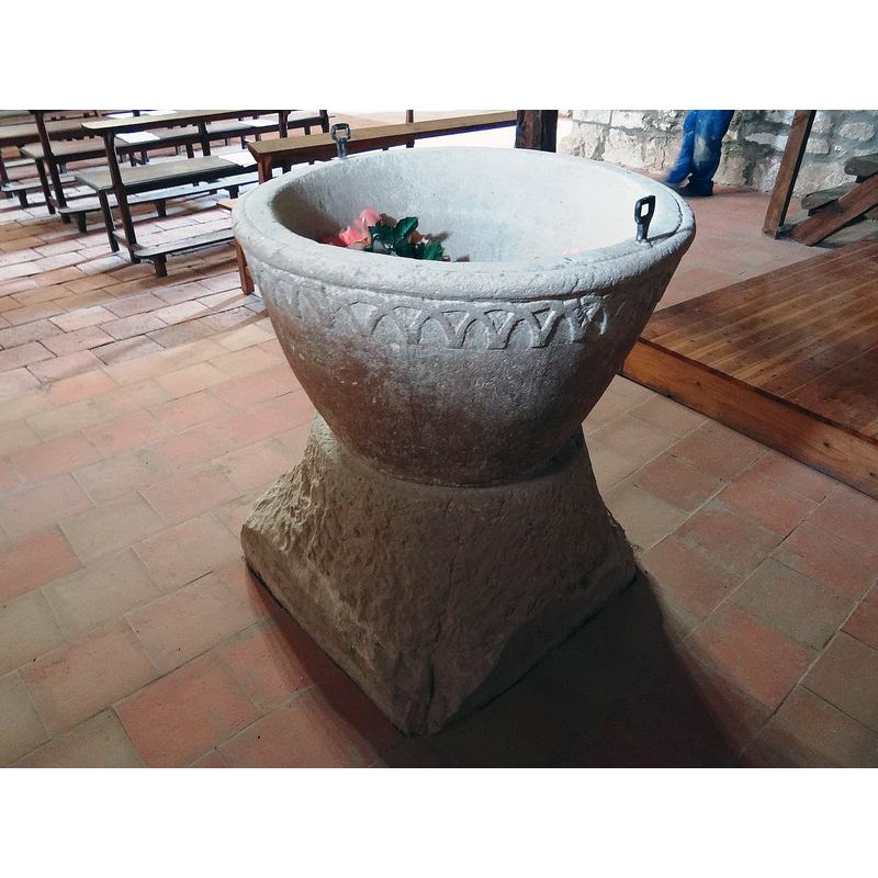 the font photographed ca. 2021 back in its original location at the west end, beneath the gallery, north side