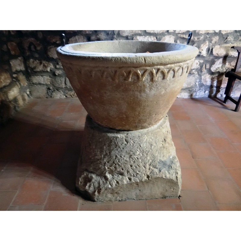 the font photographed ca. 2021 back in its original location at the west end, beneath the gallery, north side