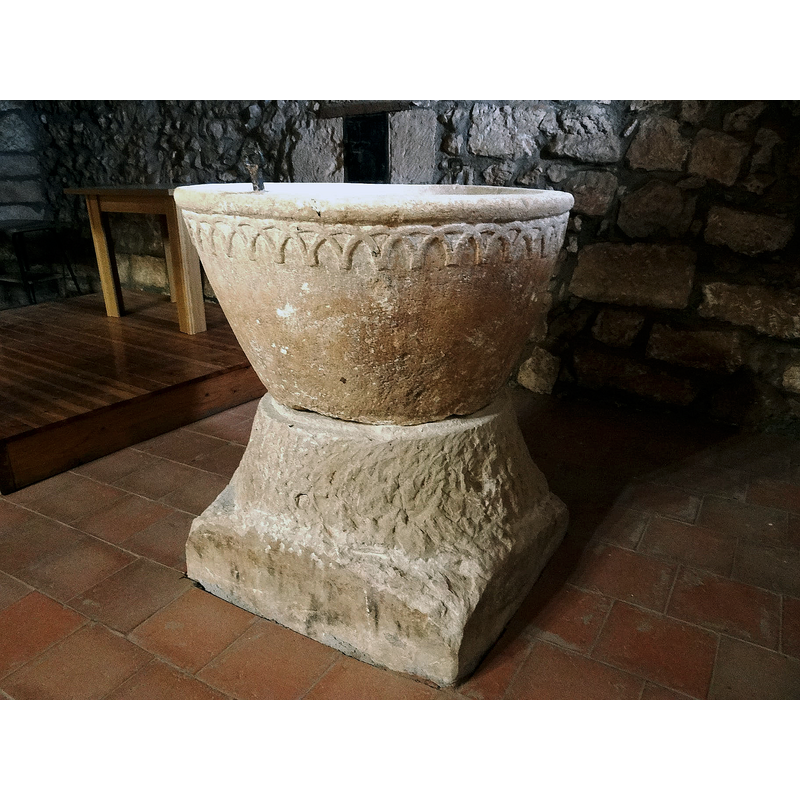 the font photographed ca. 2021 back in its original location at the west end, beneath the gallery, north side