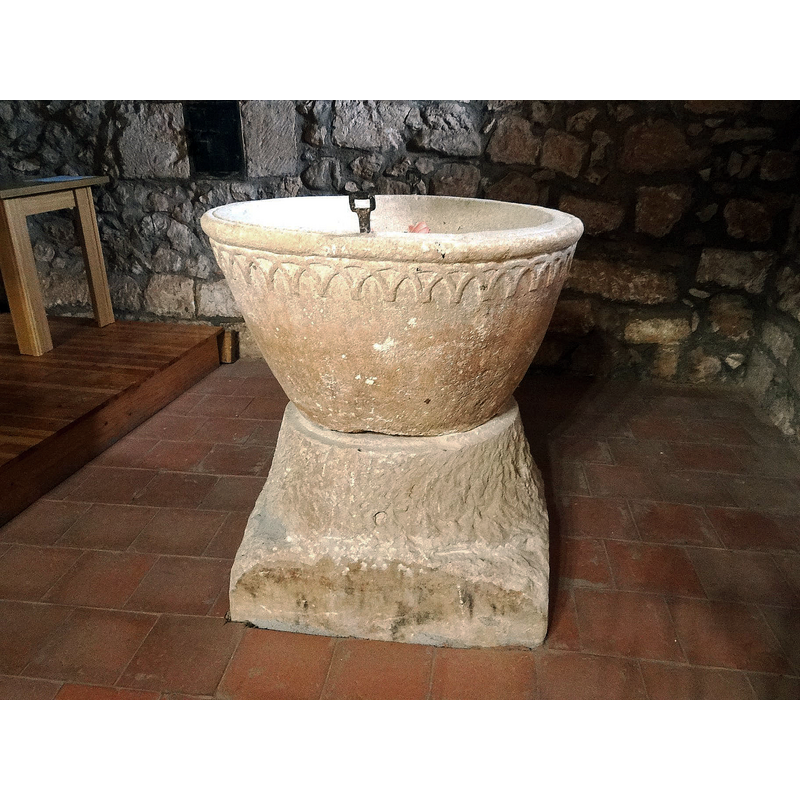 the font photographed ca. 2021 back in its original location at the west end, beneath the gallery, north side