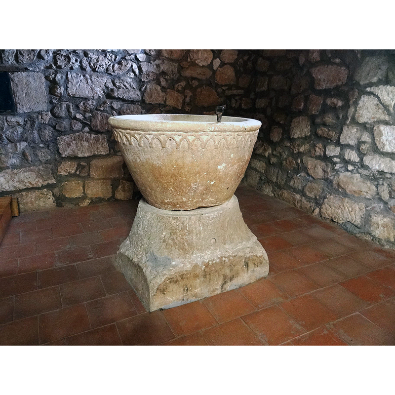 the font photographed ca. 2021 back in its original location at the west end, beneath the gallery, north side