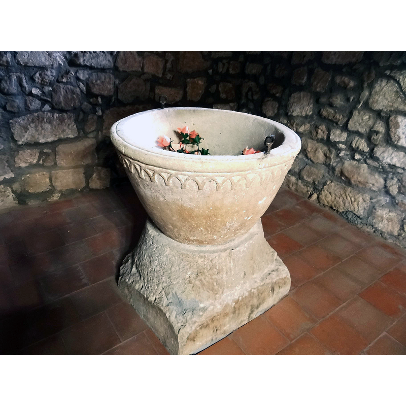 the font photographed ca. 2021 back in its original location at the west end, beneath the gallery, north side