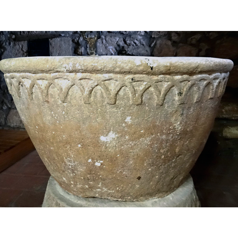 the font photographed ca. 2021 back in its original location at the west end, beneath the gallery, north side