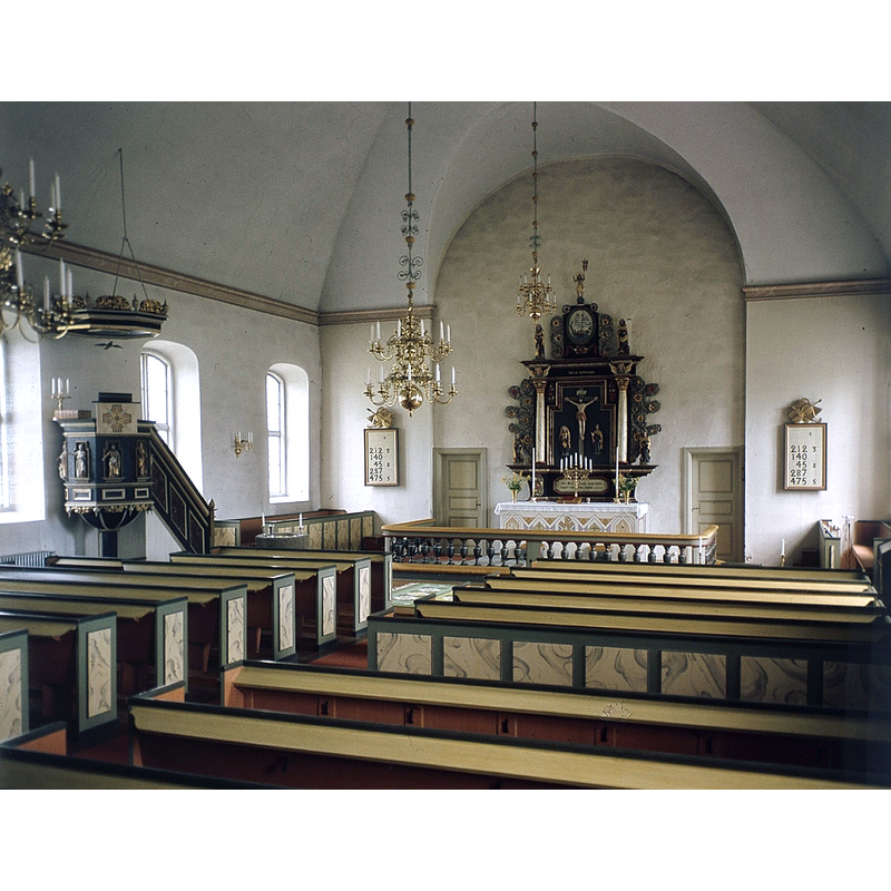 the medieval font is partially visible just east of the pulpit stairs