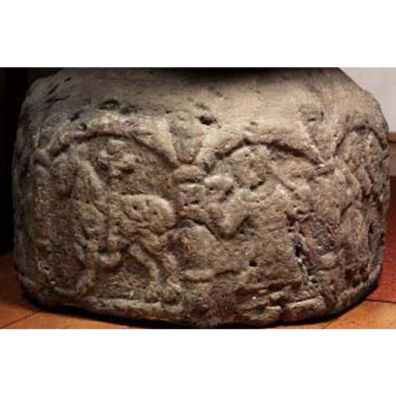 too worn and damaged for certainty but the figure in the centre arch here appears to be holding objects in both hands -- Hallbäck (1966) mentions several human figures, one with a sword, another with a crozier, etc.