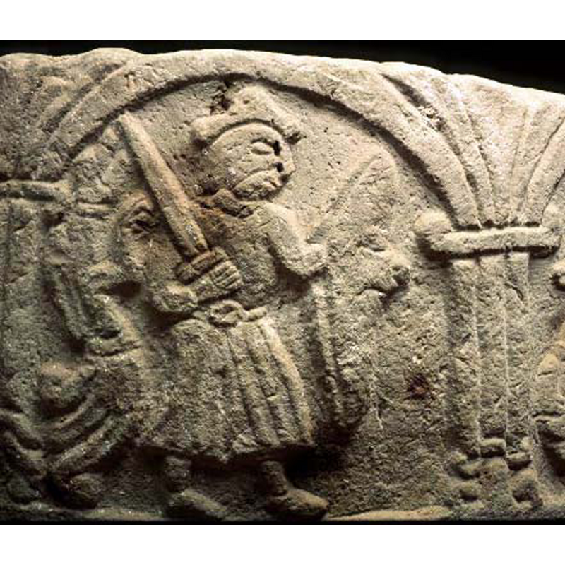 the warrior, passant to the right, appears to be attacked from behind by a dragon(?) rampant on his back, but he is facing the right, oblivious(?) of the beast behind him