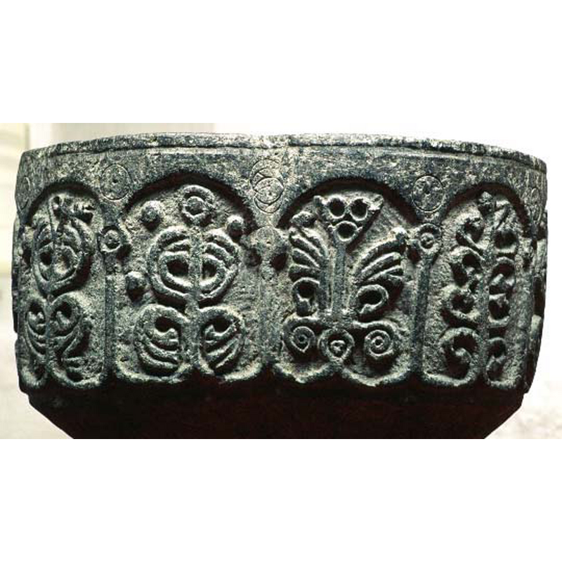 very stylised, the capitals just a circle with an inscribed bead