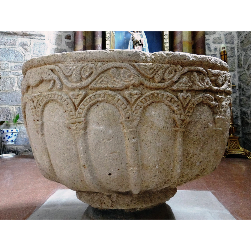 view of the west side -- the arch-heads have beaded-tape decoration; the capitals have varied shape and decoration; the columns become piping that contiunues down under the bowl