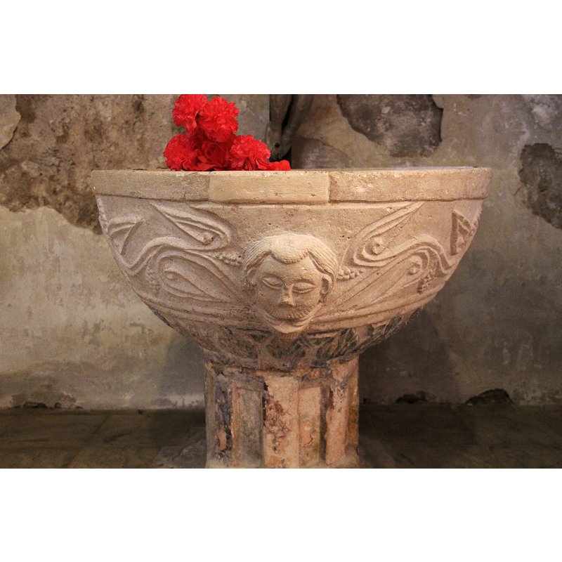 notice the new-stone insert repair; the damage would correspond to the former location of a metal anchoring for the font cover, as there is similar damage -not repaired- to the opposite side, at the back