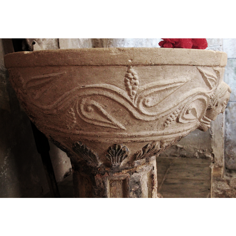 stemming from the head and running all around the basin; these on the left of the human head issuing them